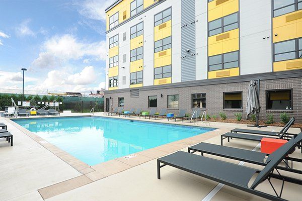 Pool view at a Minneapolis apartment with a colorful yellow exterior on the building