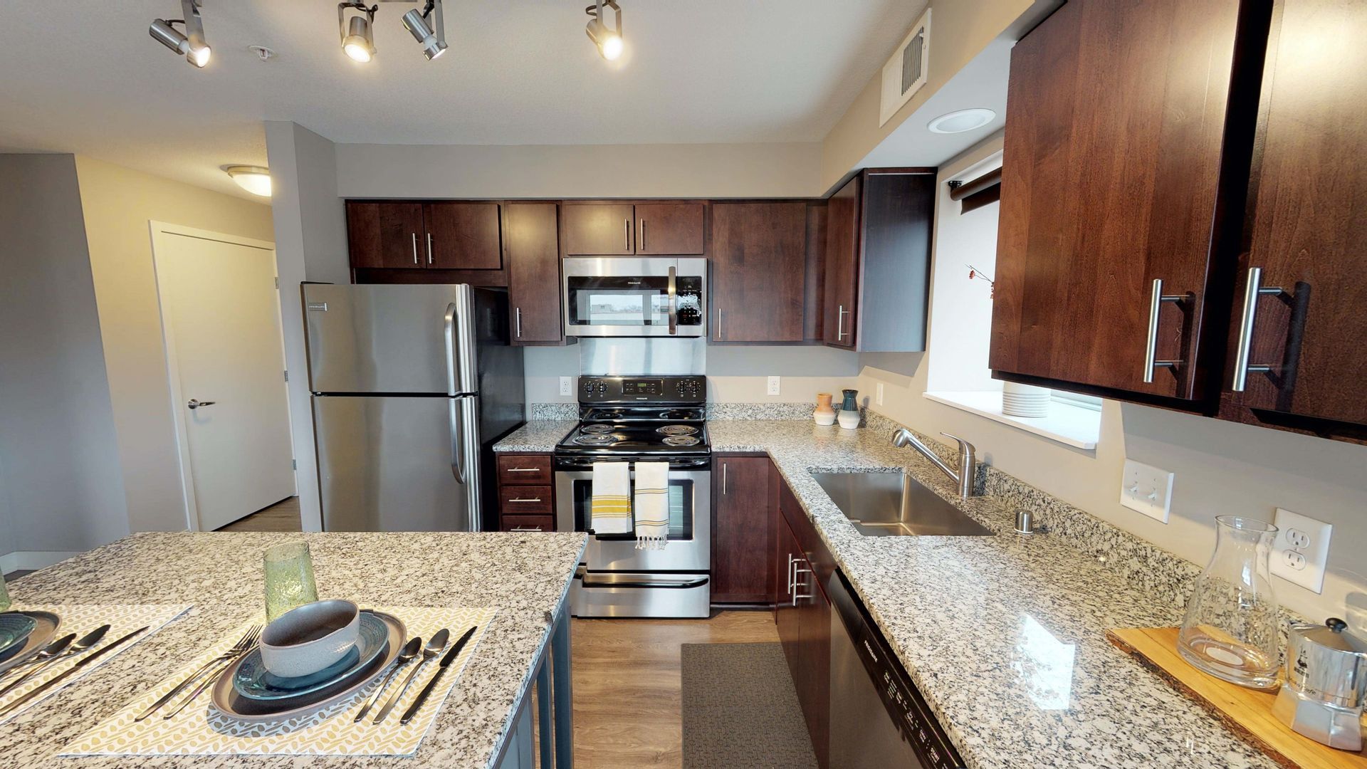Kitchen with granite countertops and gas appliances at Spectrum apartments and townhomes in Minneapolis