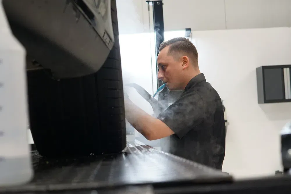 A man in a black shirt is working on a computer.