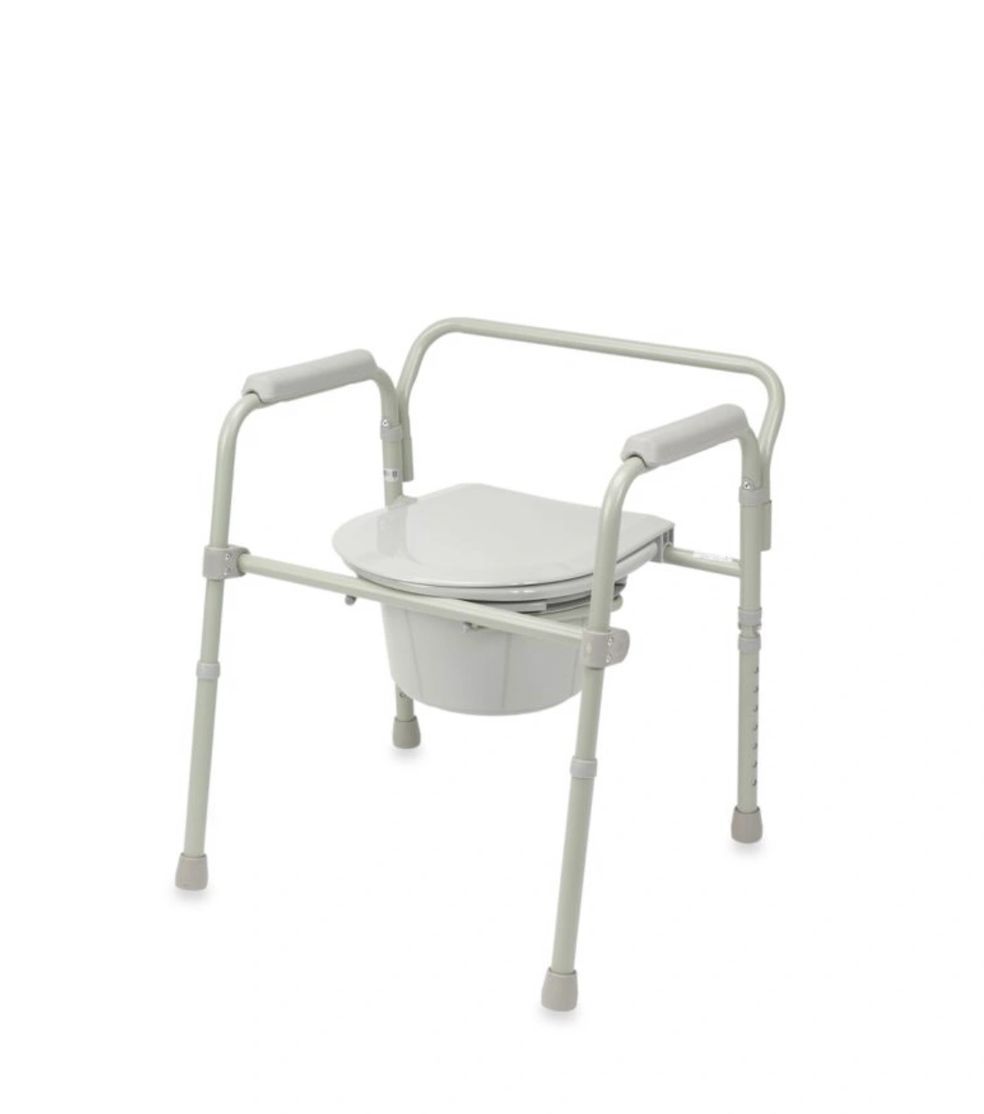 White folding commode chair with armrests and adjustable legs on a white background