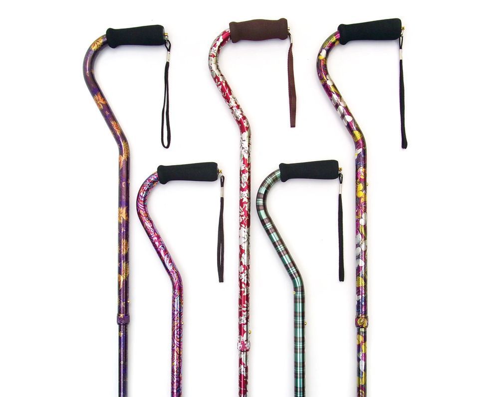 Five colorful patterned walking canes with black handles arranged on a white background