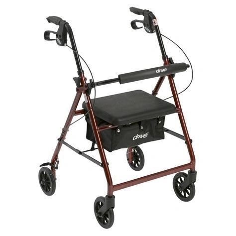 Red four-wheeled rollator walker with seat and black handles on white background