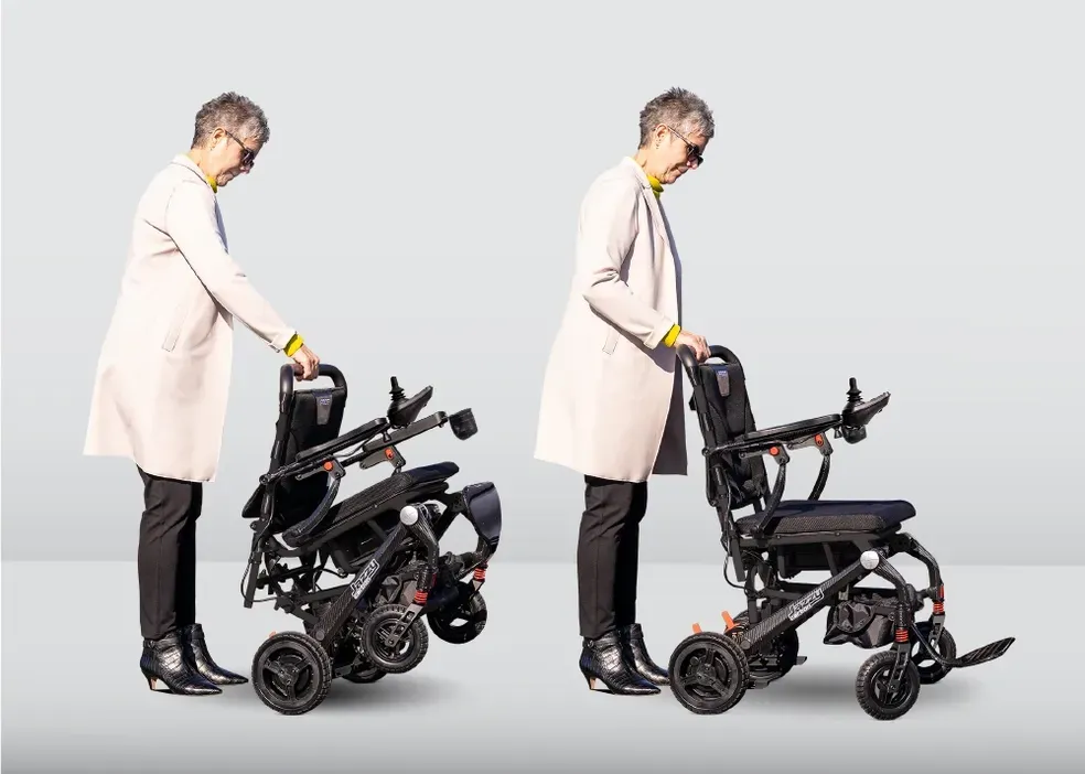 Person folding a black mobility scooter in two stages against a light gray background