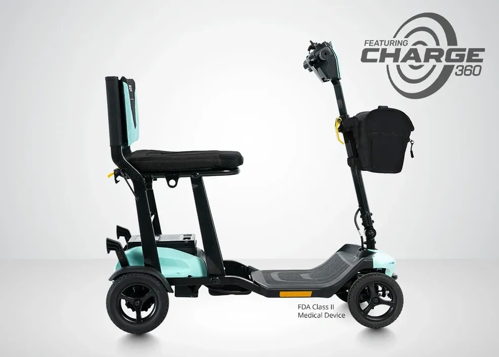 Black mobility scooter with seat, front basket, and three wheels on a white background