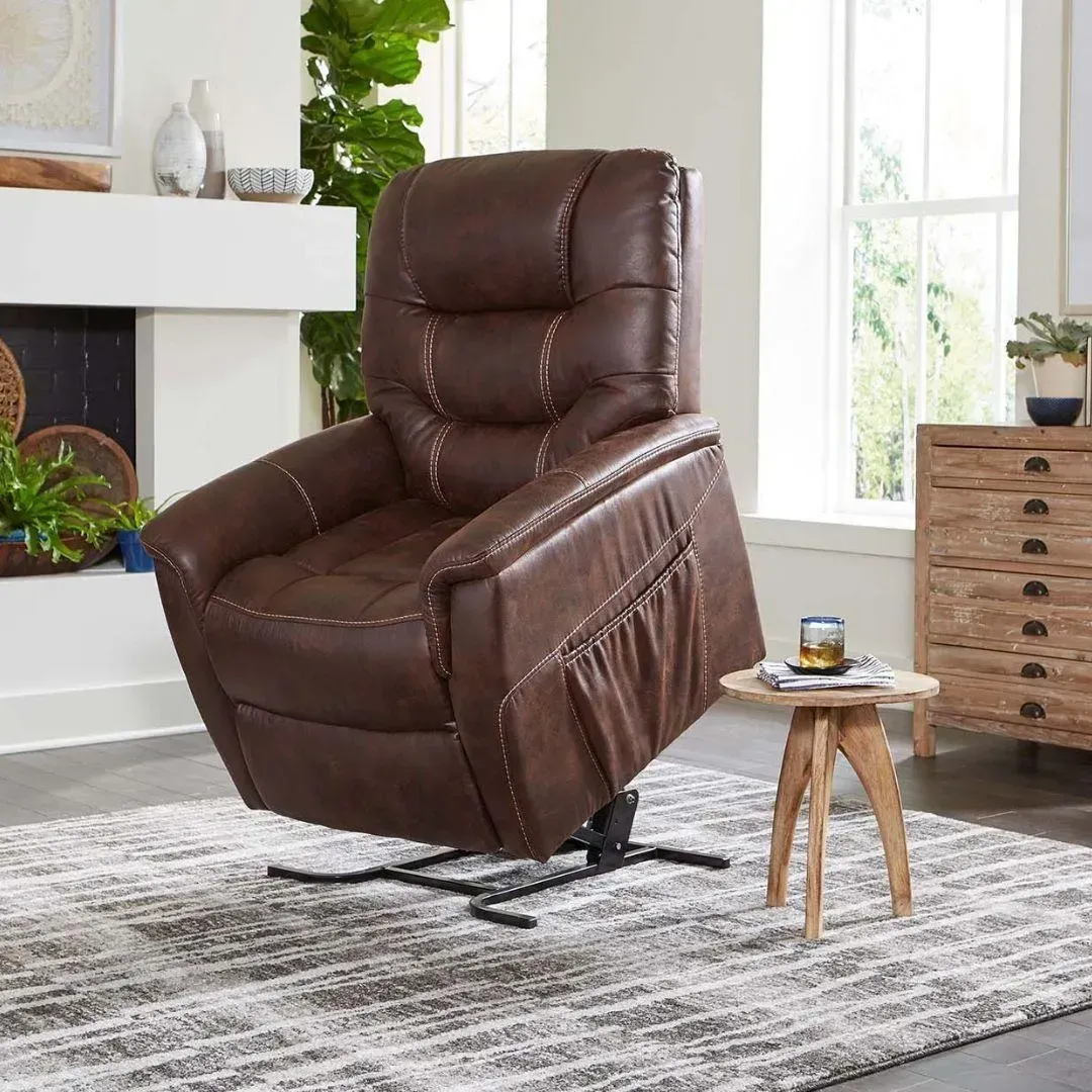 Brown leather recliner chair in a bright living room beside a small wooden side table and rug
