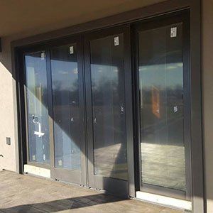 A row of sliding glass doors on a building.