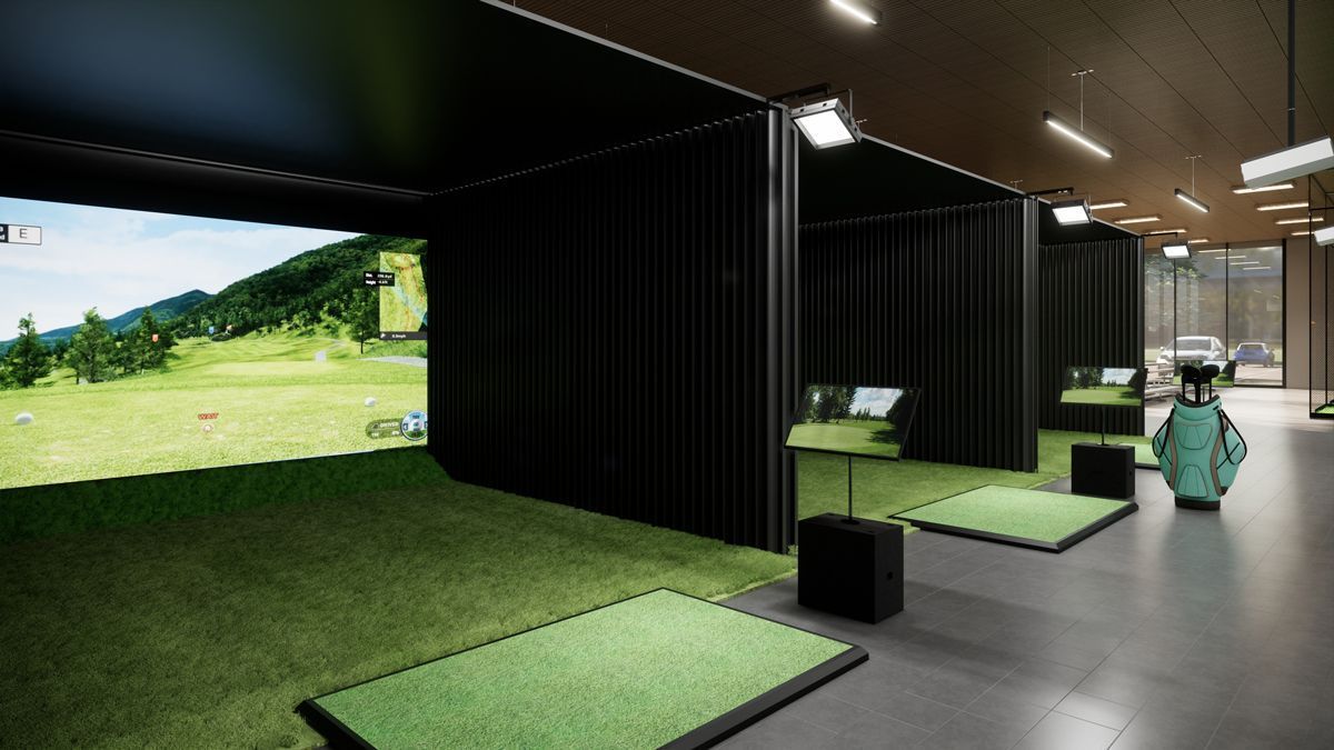 A modern indoor golf facility featuring multiple simulator bays with projection screens and green turf hitting mats.