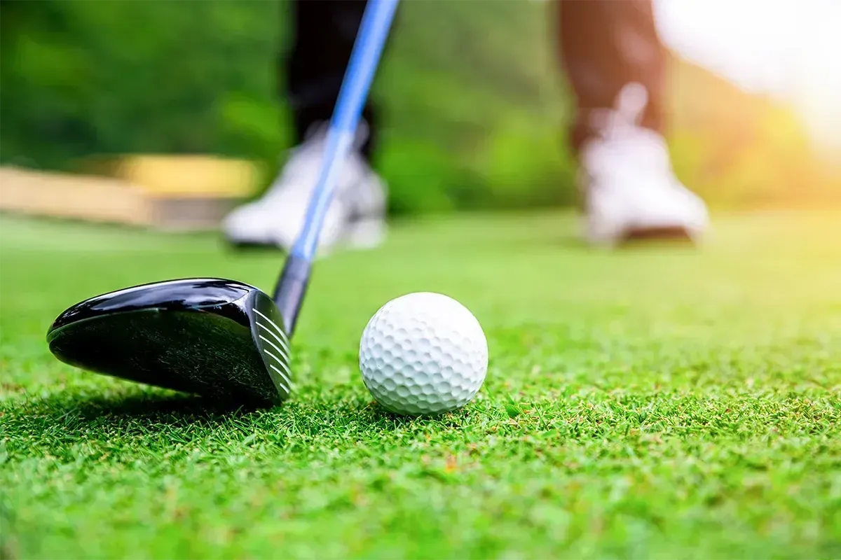 Close up of golf ball and club