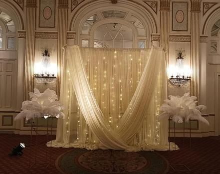 A large room with a white curtain and feathers.