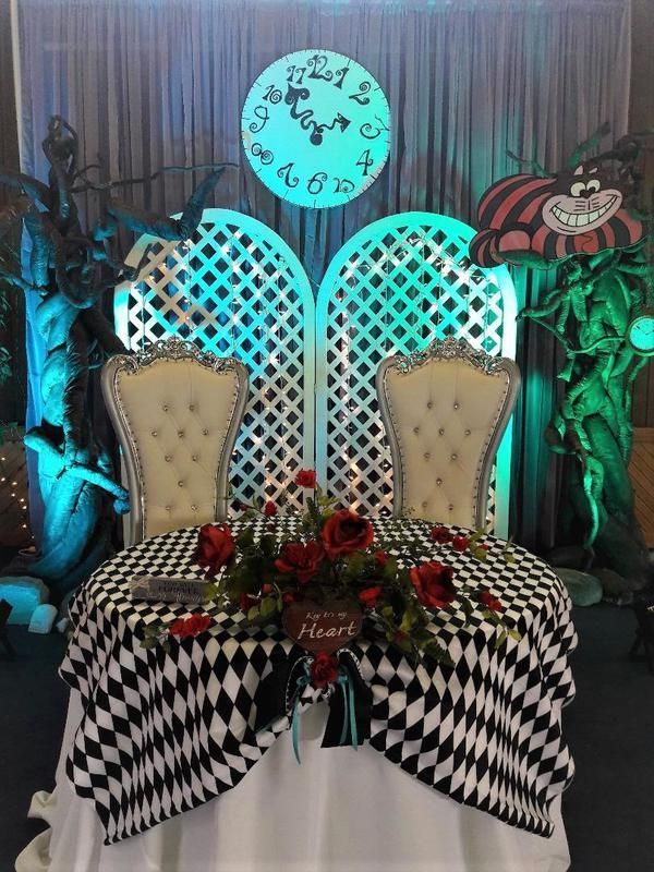 A table with two chairs and a clock on it