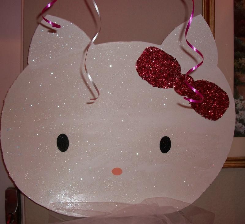 A white hello kitty with a red bow on her head