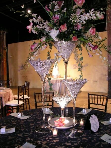 A table with martini glasses and flowers on it