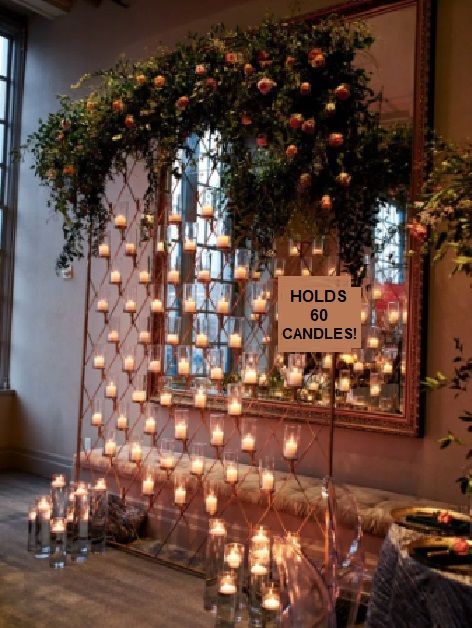 A sign that says holds 60 candles in front of a mirror