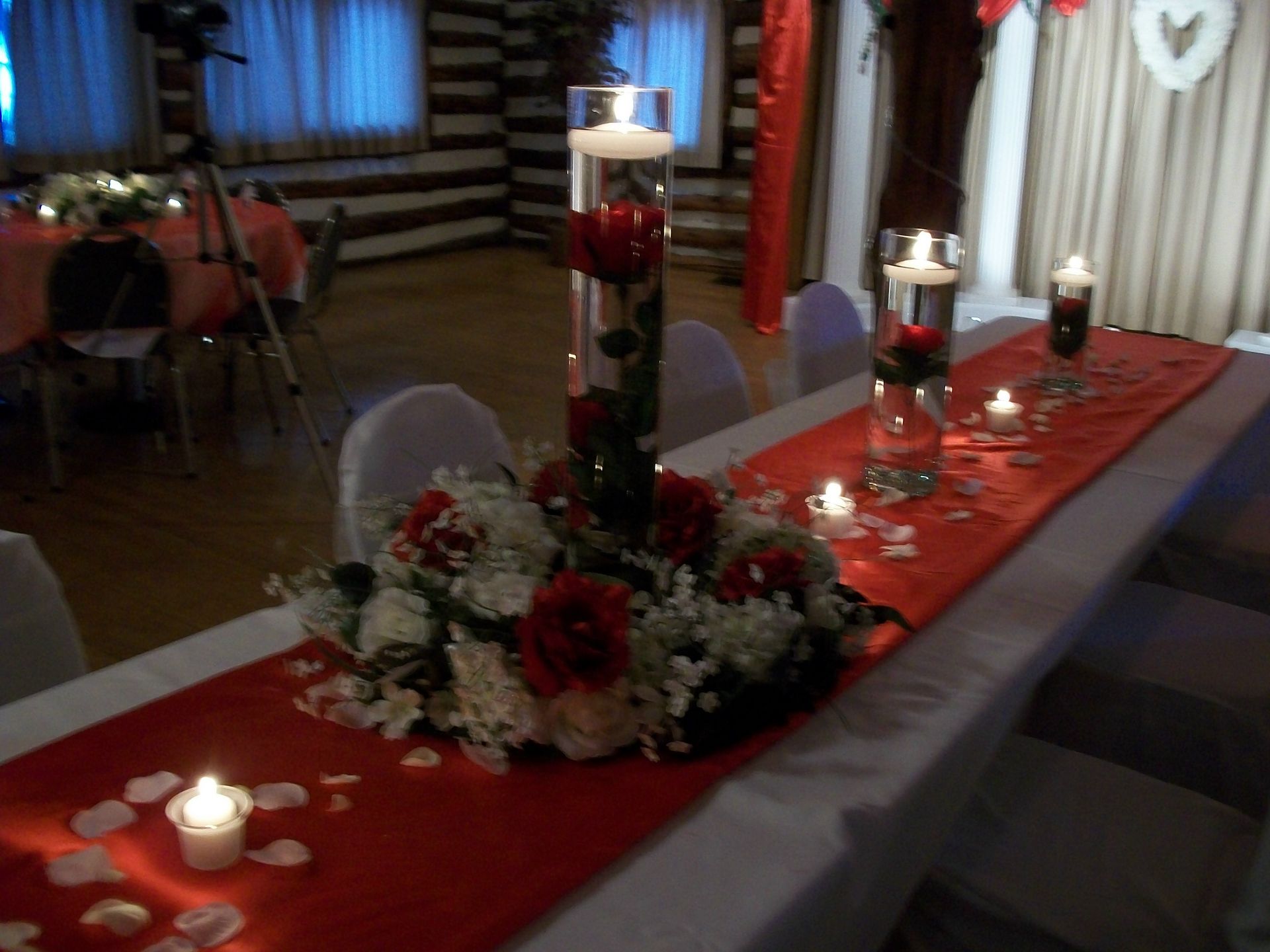A long table with flowers and candles on it