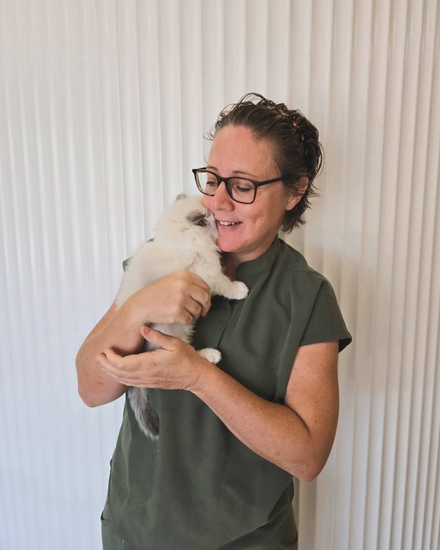 A Woman in Glasses Holding a Fluffy White Puppy — The Neighbourhood Vet in Tewantin, QLD