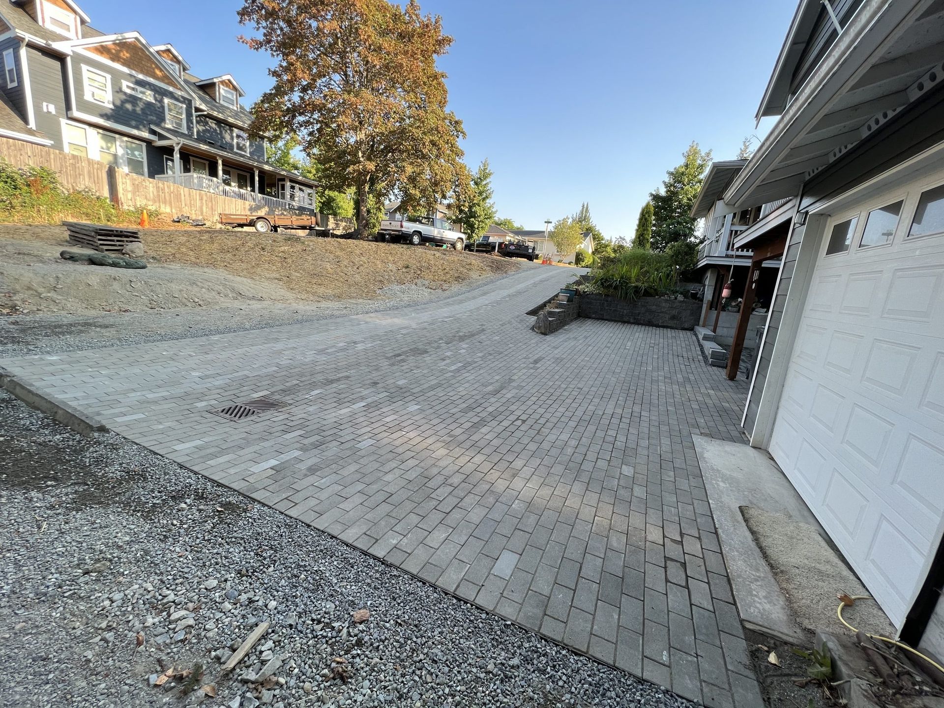 A brick driveway is being built in front of a house in Monroe, WA.