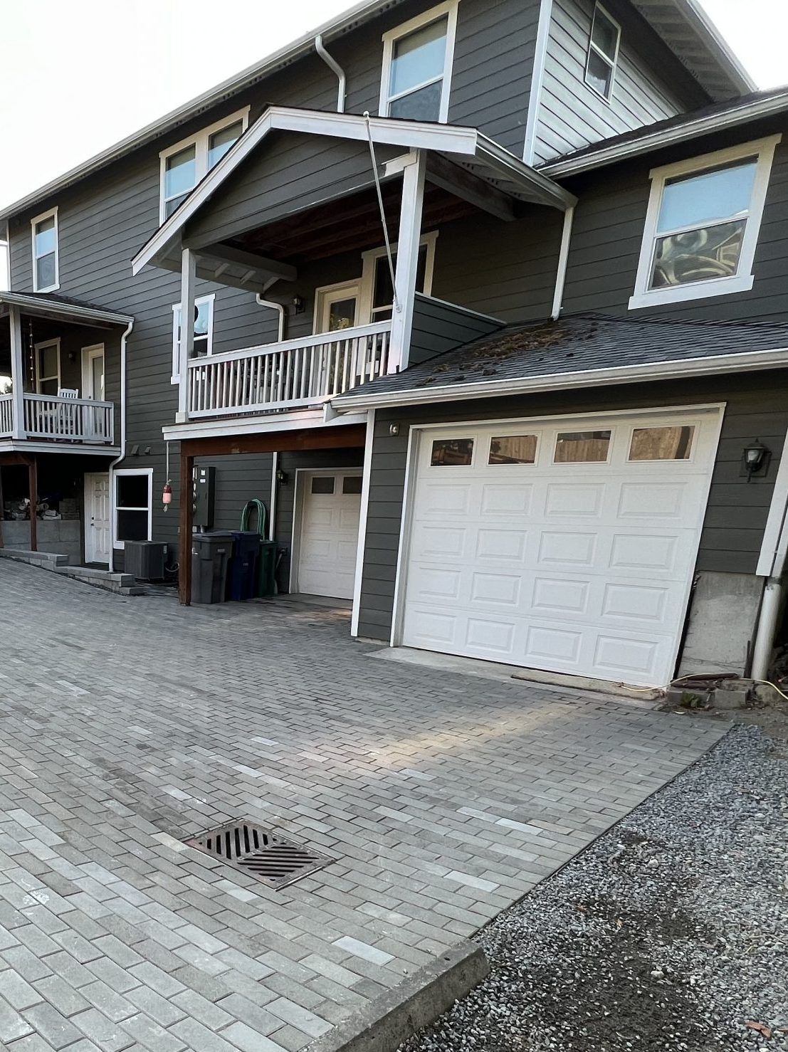A large house with a white garage door and a balcony in Monroe, WA.