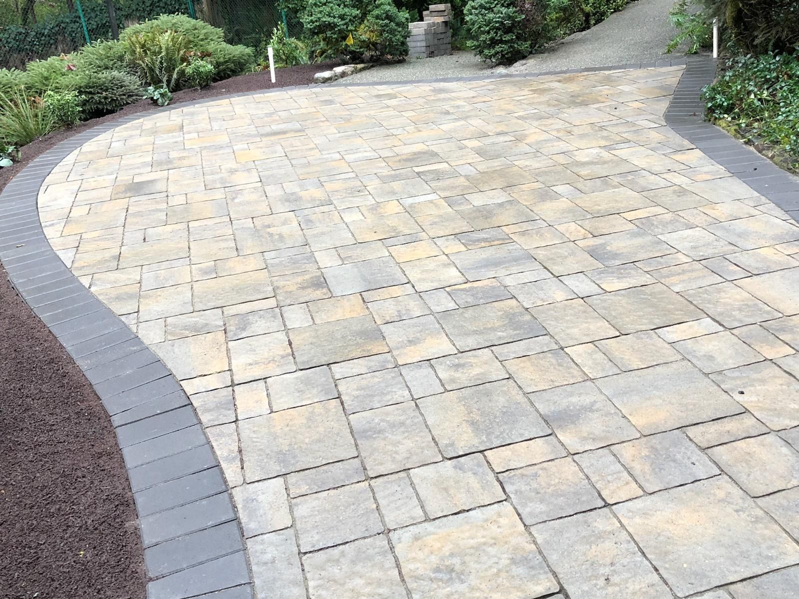 A brick driveway with a curve in the middle of it in Monroe, WA.