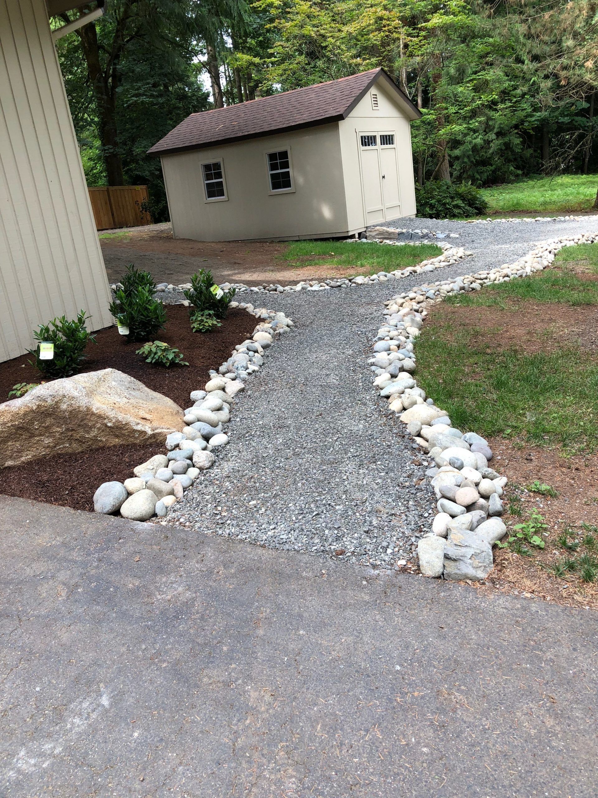 A gravel path leading to a shed in the backyard in Monroe, WA.