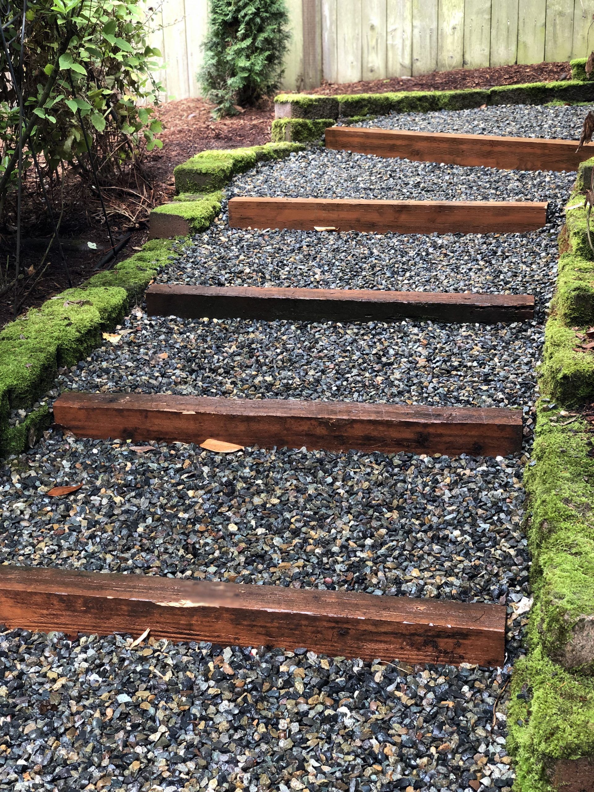 A row of wooden steps leading up to a gravel path in Monroe, WA.