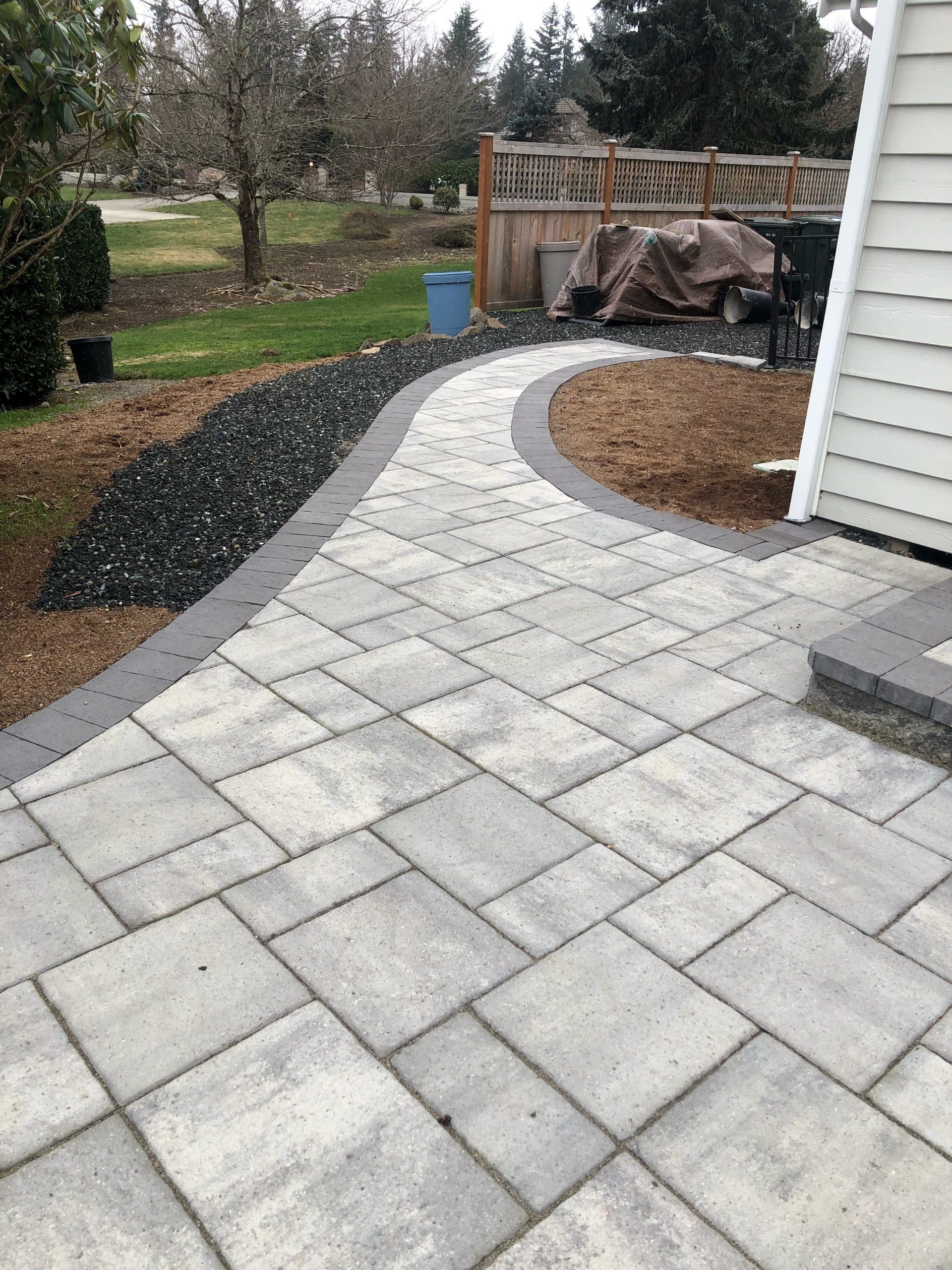 A patio with a walkway leading to a house in Monroe, WA.