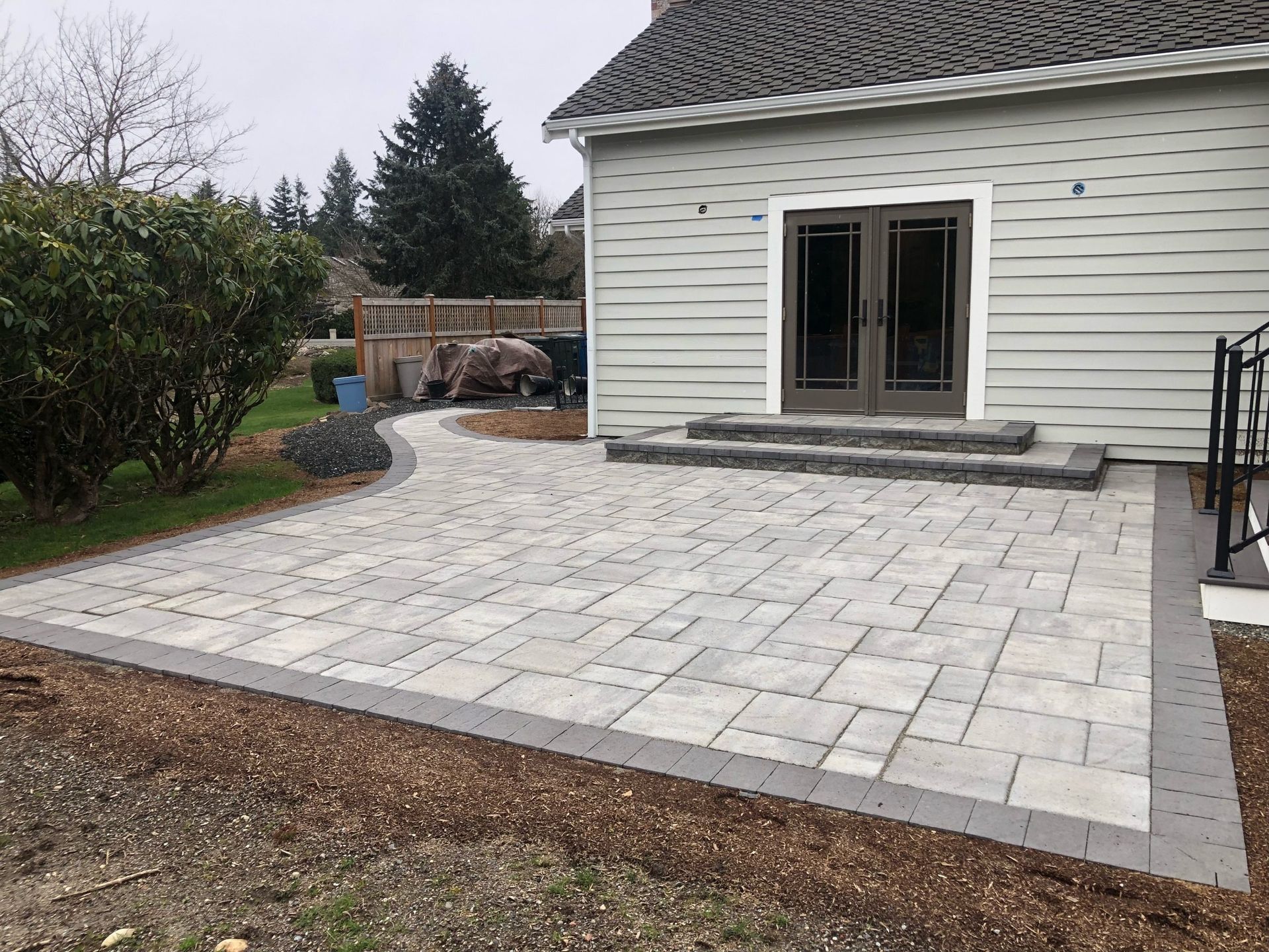 A house with a patio and stairs in front of it in Monroe, WA.