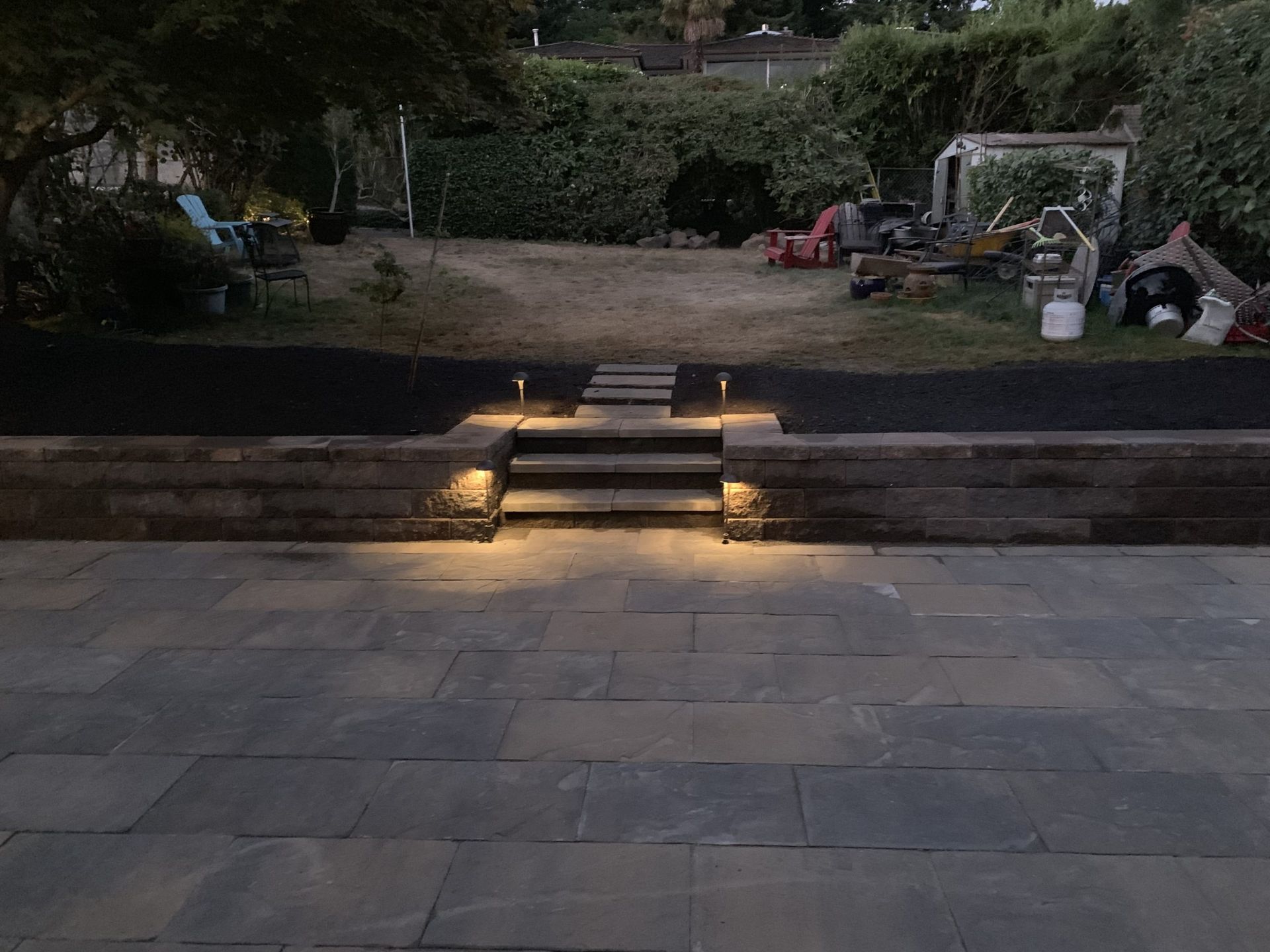 A patio with stairs and a wall with lights on it in Monroe, WA.