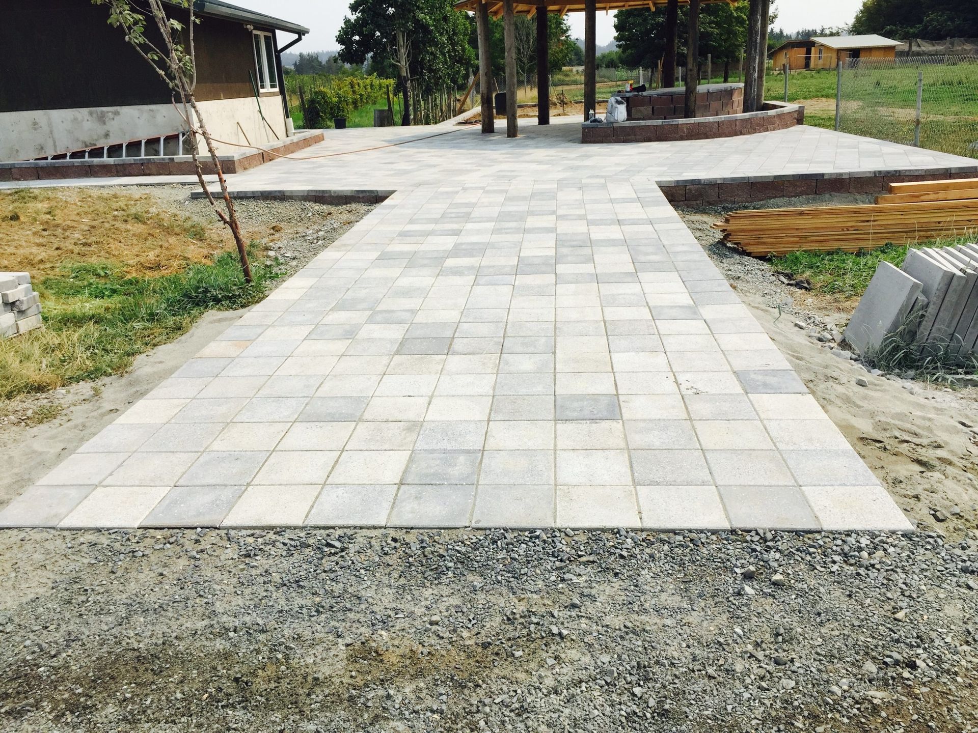 A brick walkway is being built in a yard in Monroe, WA.