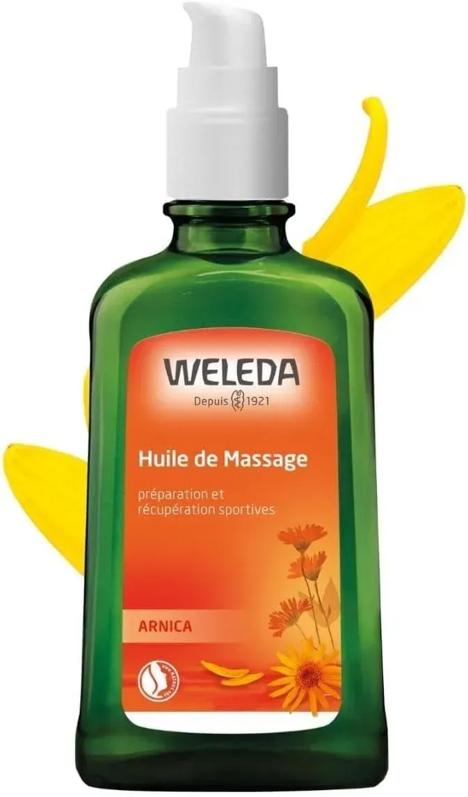 Weleda Arnica massage oil bottle with green glass and orange label on white background