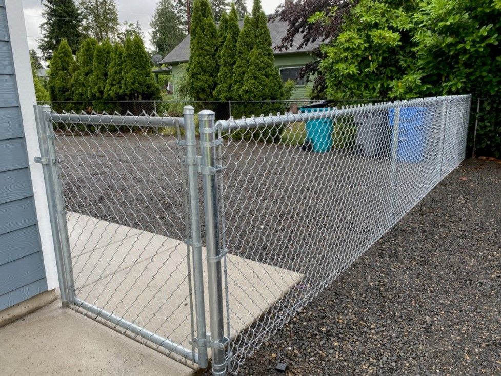 A blurry picture of a person behind a chain link fence