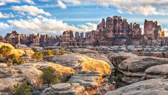 Rocky desert landscape with towering red rock formations.