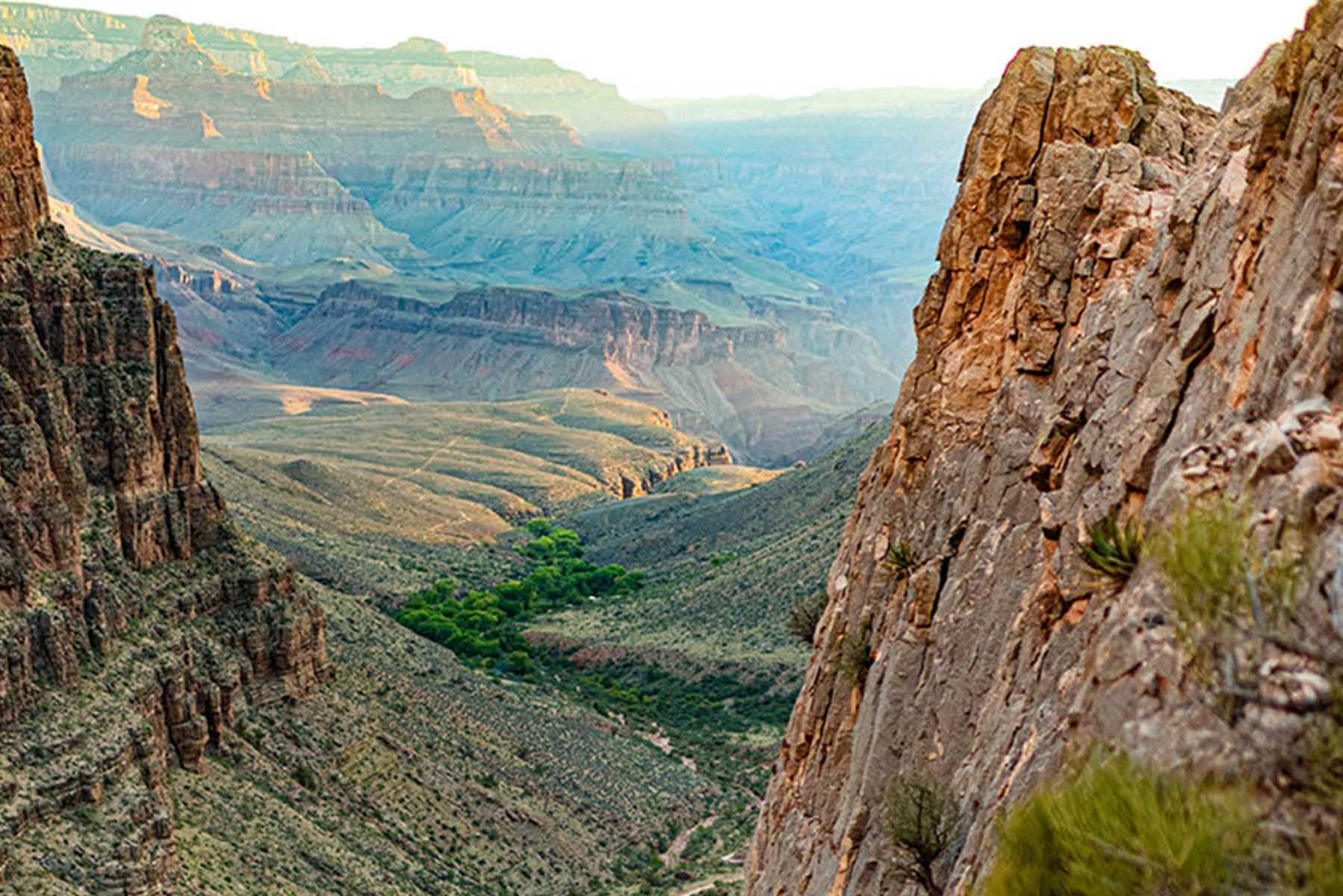 A view of a canyon from the top of a mountain.