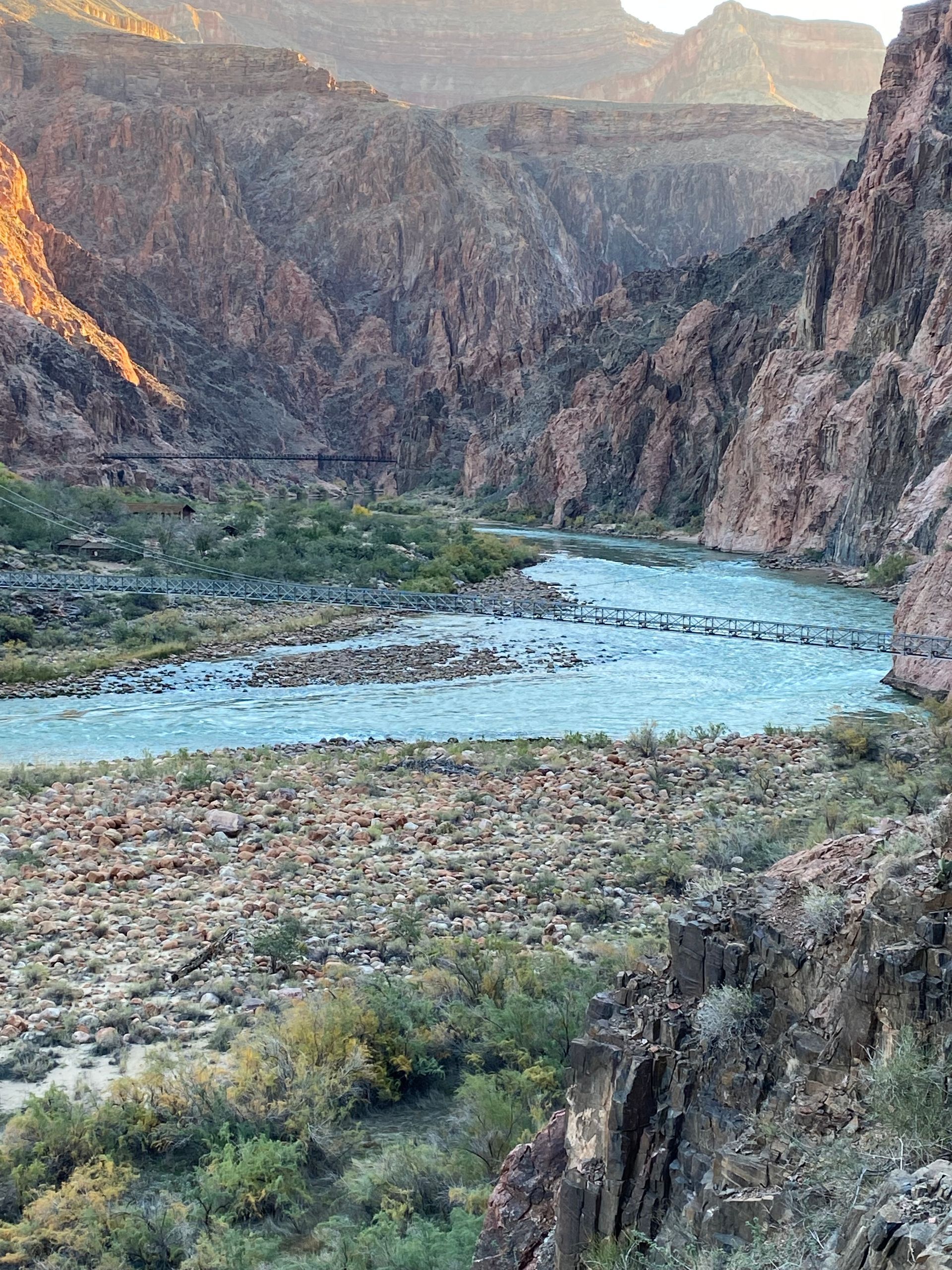 A river running through a canyon with mountains in the background.
