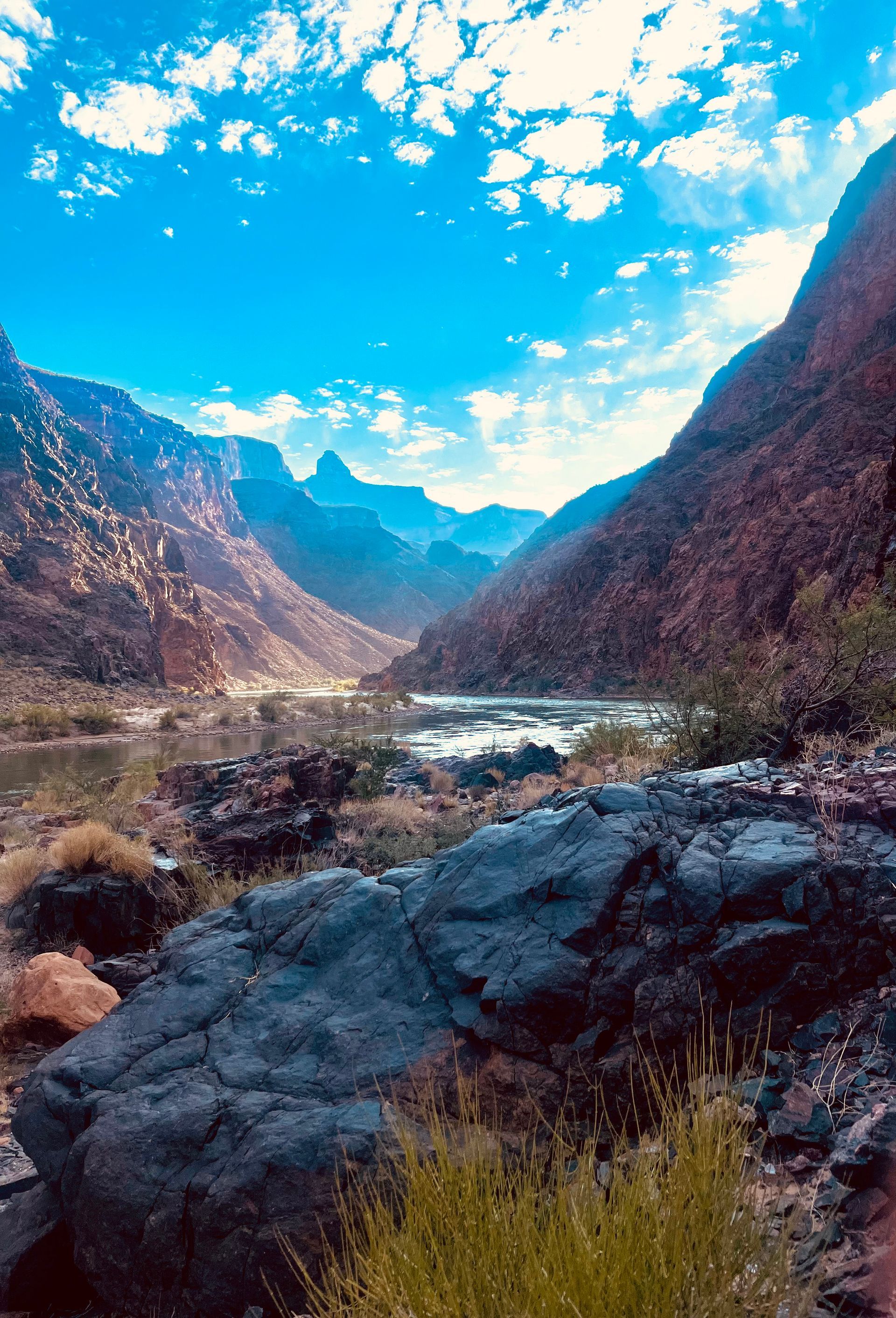 A river runs through a valley between two mountains.