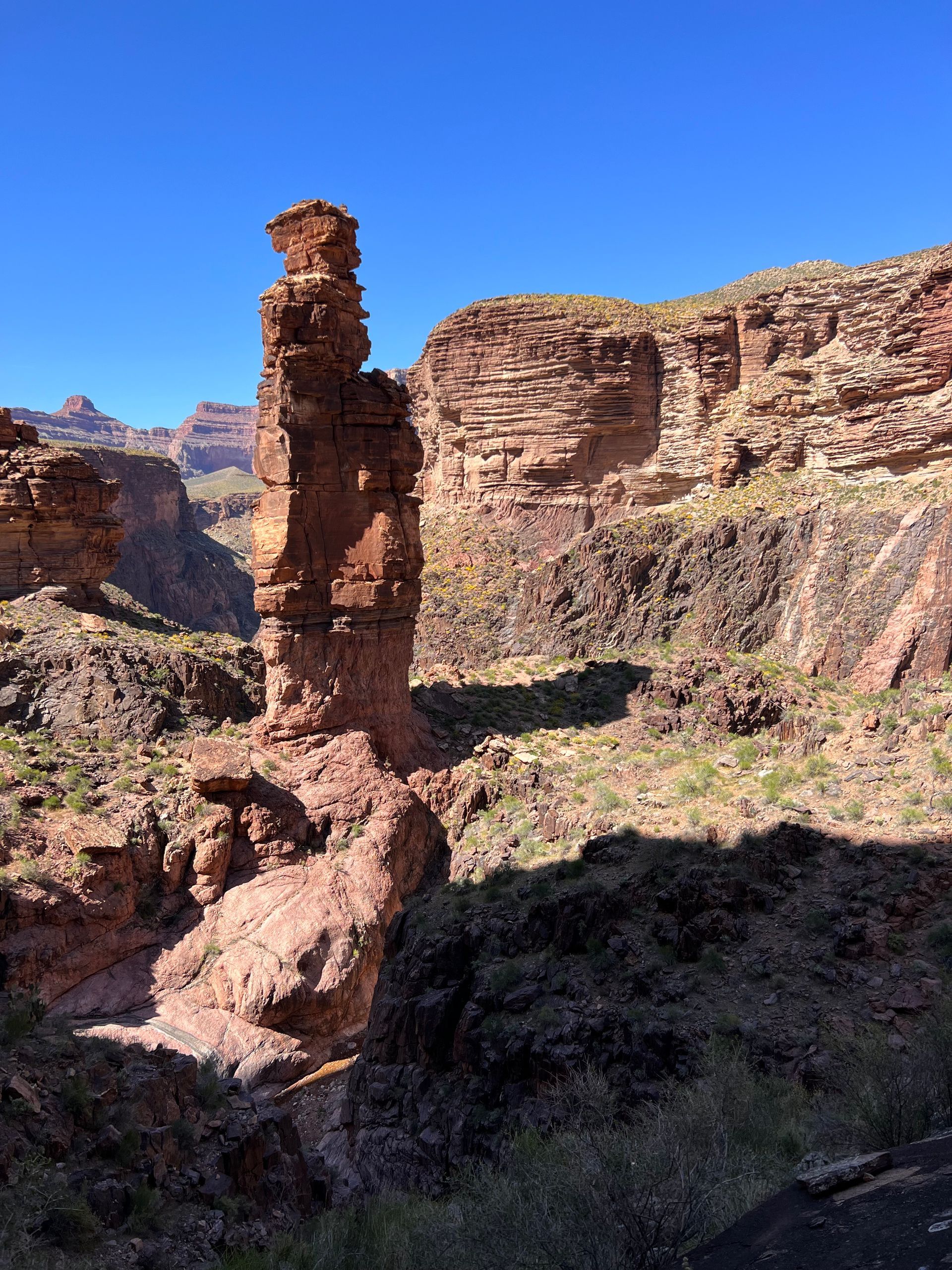 A large rock formation in the middle of a canyon.
