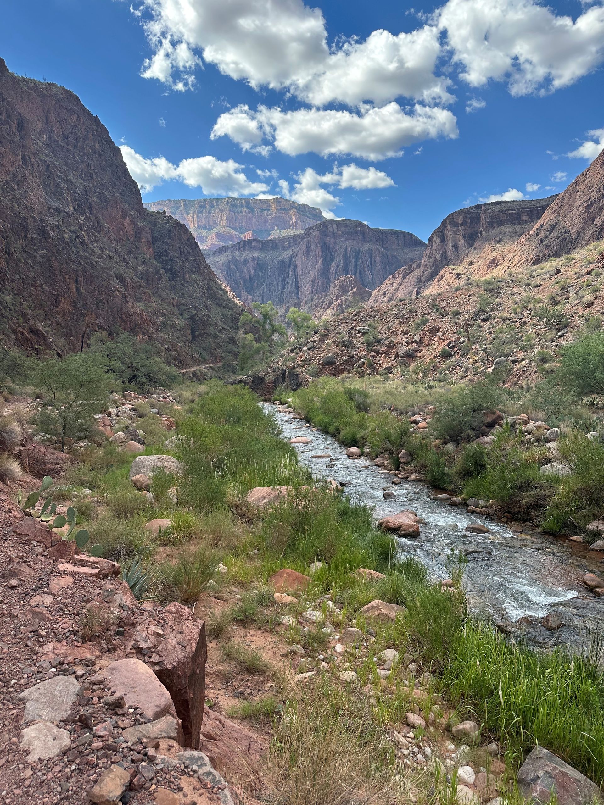 A river runs through a valley between two mountains.