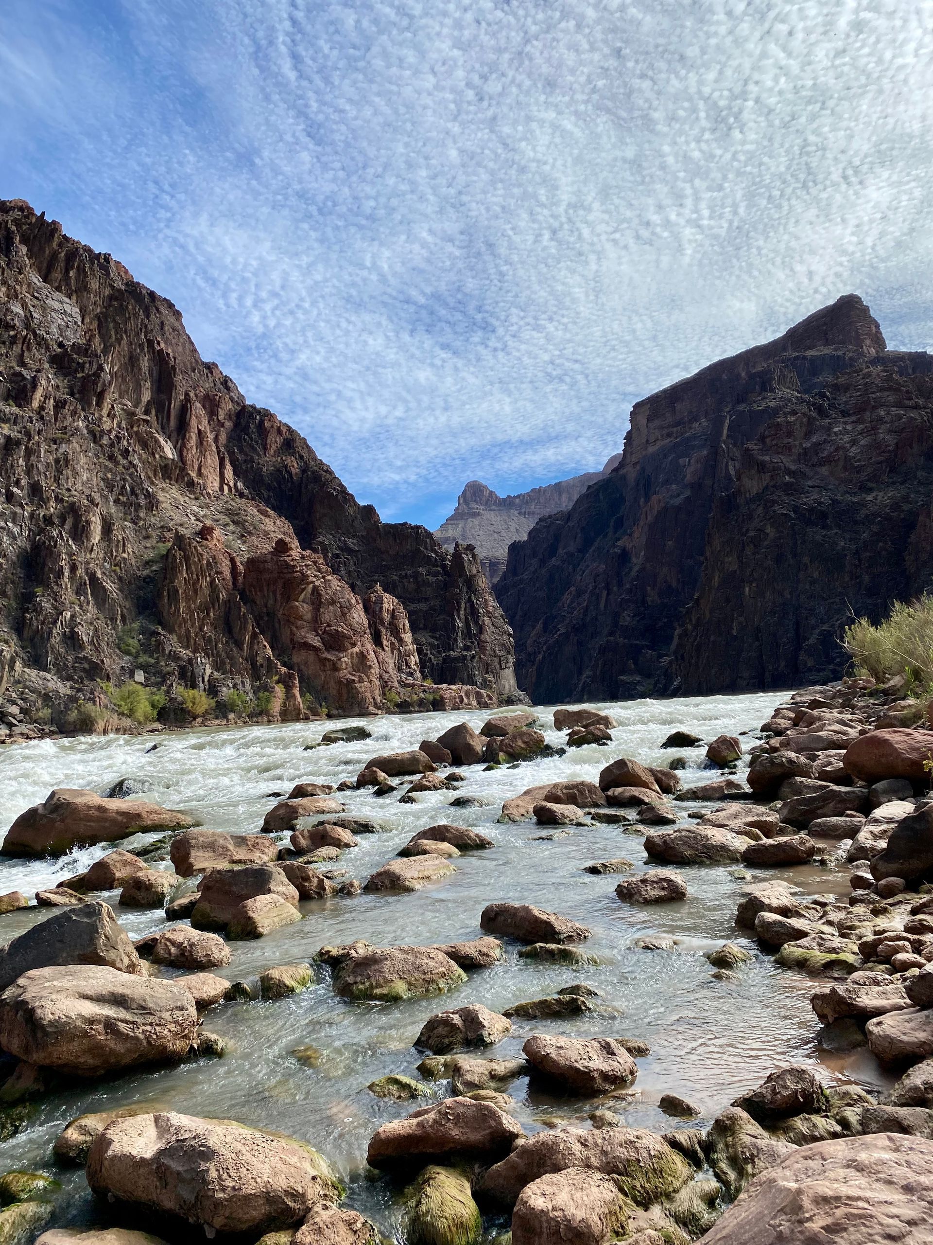 A river flowing through a canyon surrounded by rocks and mountains.
