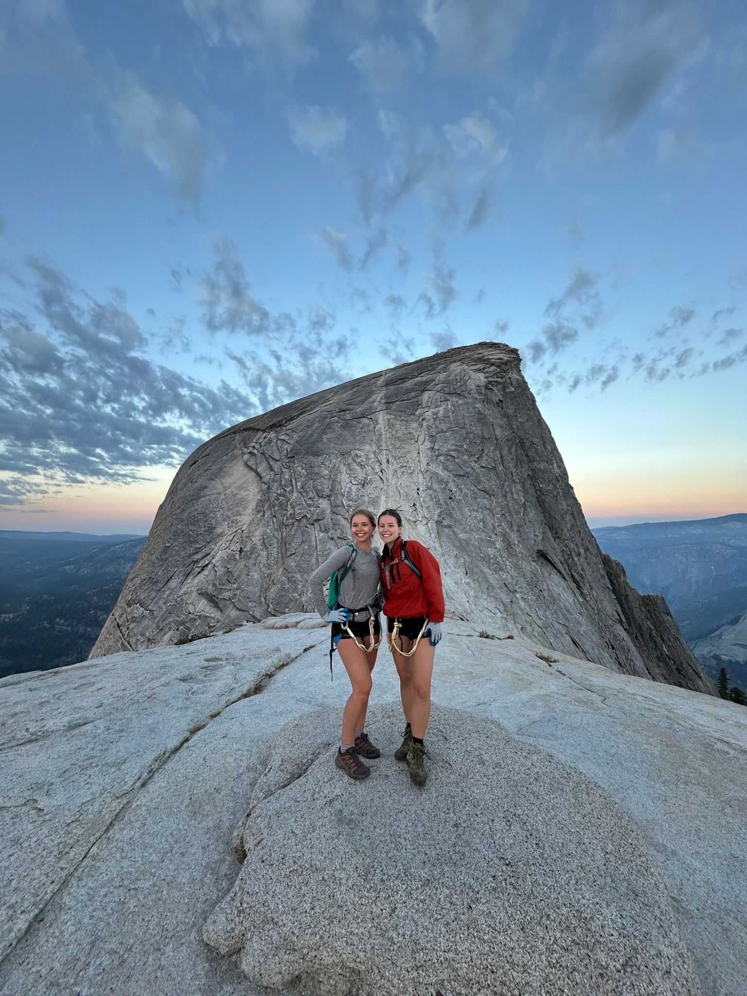 A Man With a Backpack is Walking Down a Trail in the Mountains