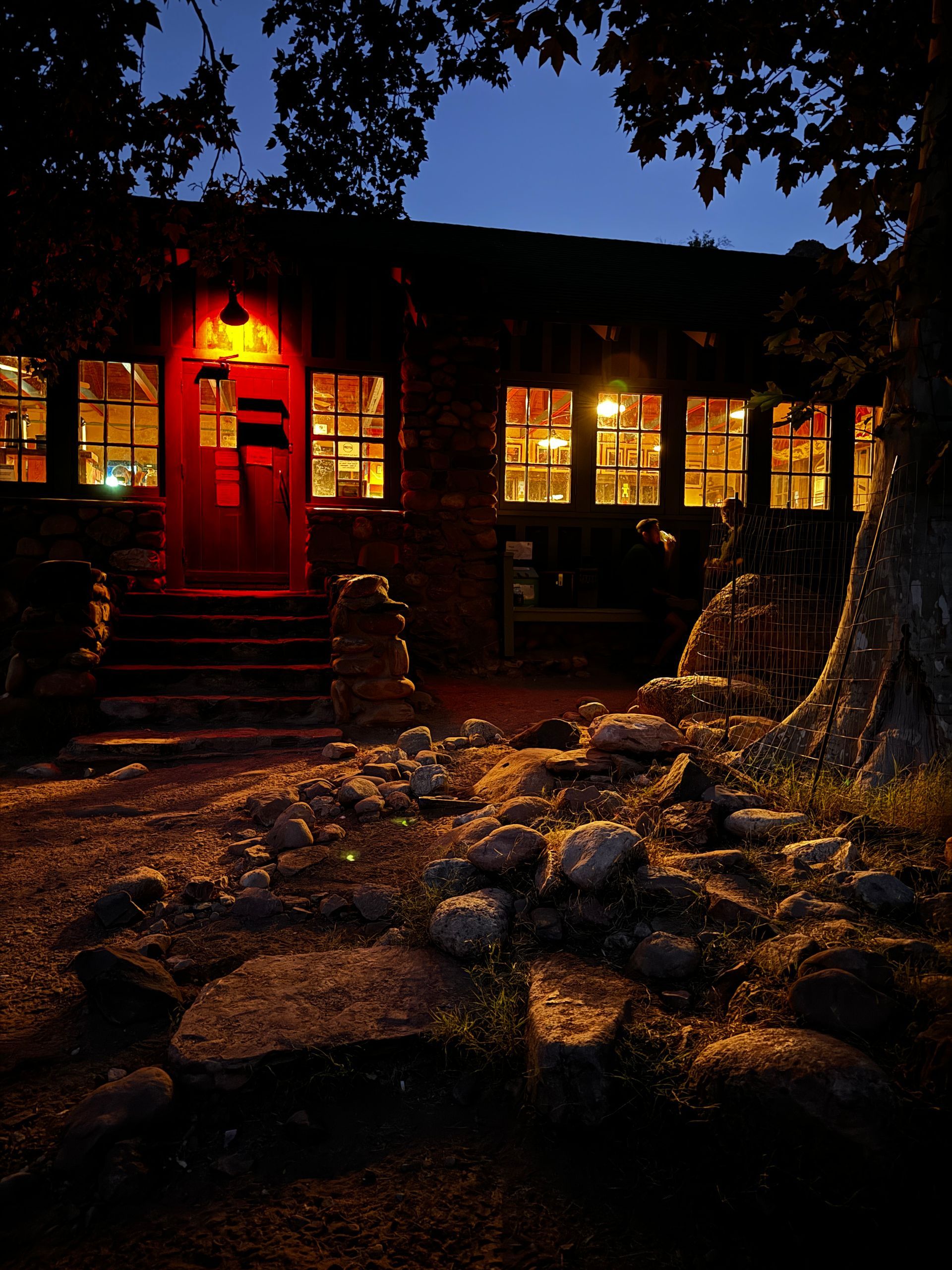 A house is lit up at night with a red door