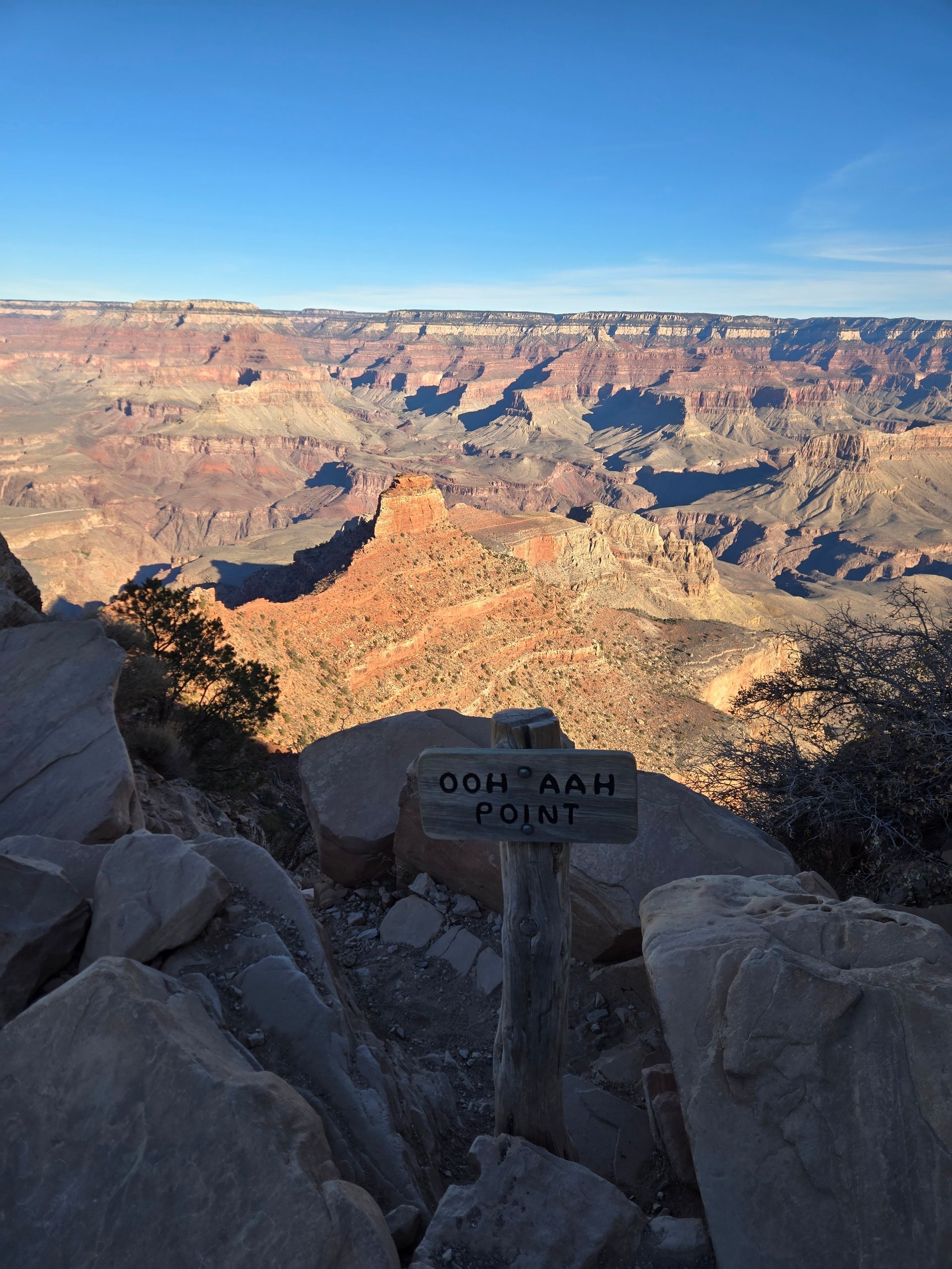 View of Grand Canyon from Ooh Aah Point sign on a sunny day.