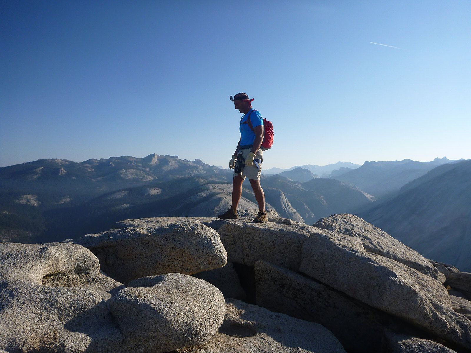a person standing on a rock in half dome