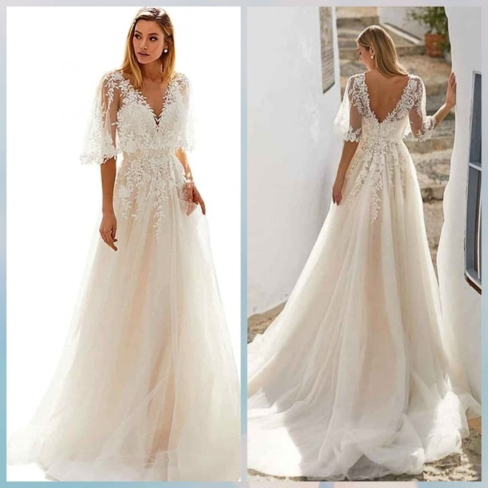 White lace wedding dress with long tulle train, shown front and back on a model outdoors.