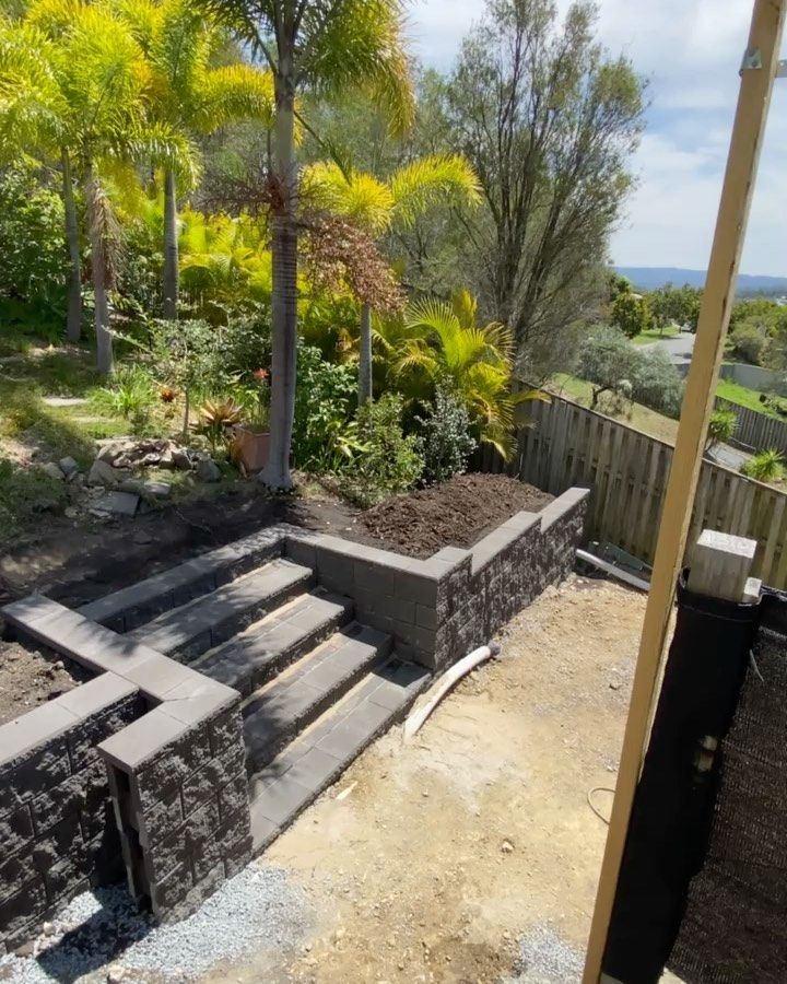 A staircase is being built in a garden with trees in the background — Turnscape Landscaping In Broadbeach, QLD