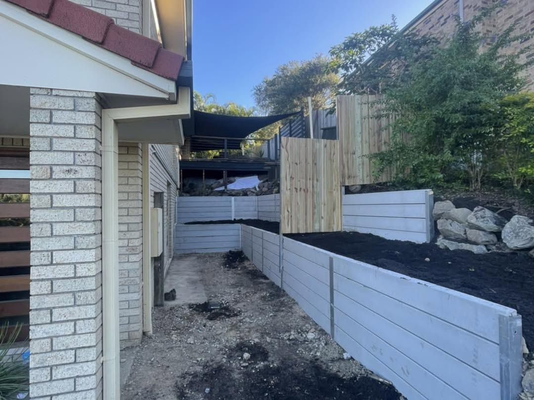 A brick building with a wooden fence in front of it. — Turnscape Landscaping in Burleigh Heads, QLD