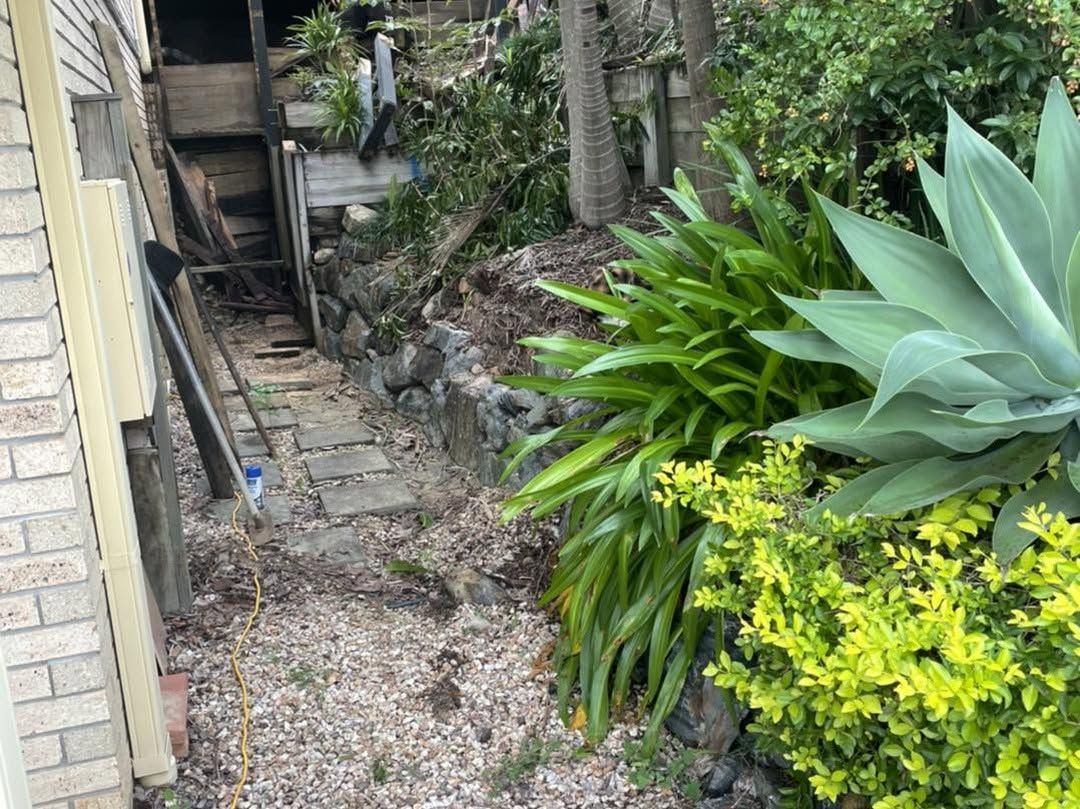 A path leading to a house surrounded by plants and rocks. — Turnscape Landscaping in Palm Beach, QLD