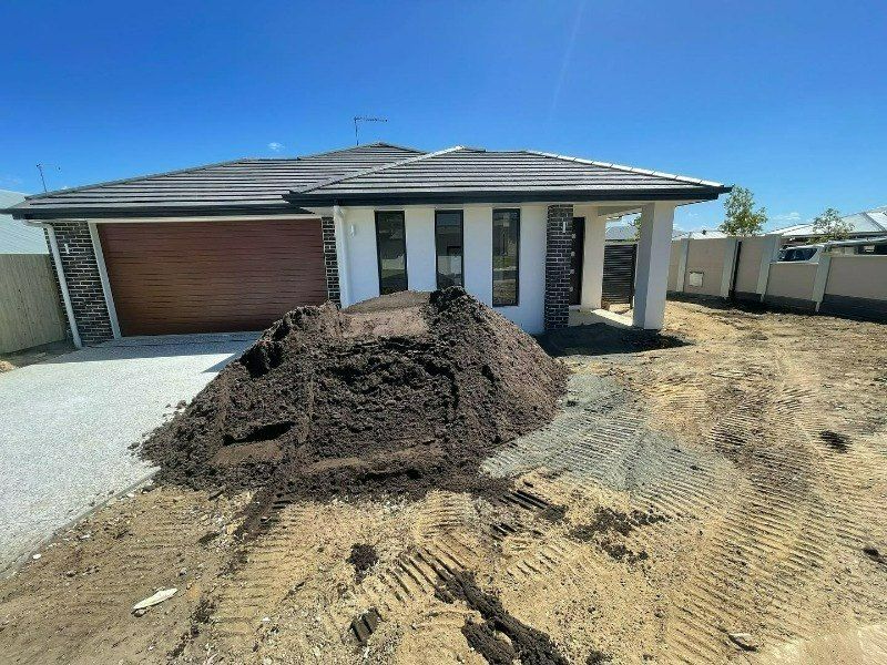 A Pile of Dirt is in Front of a House — Turnscape Landscaping In Broadbeach, QLD
