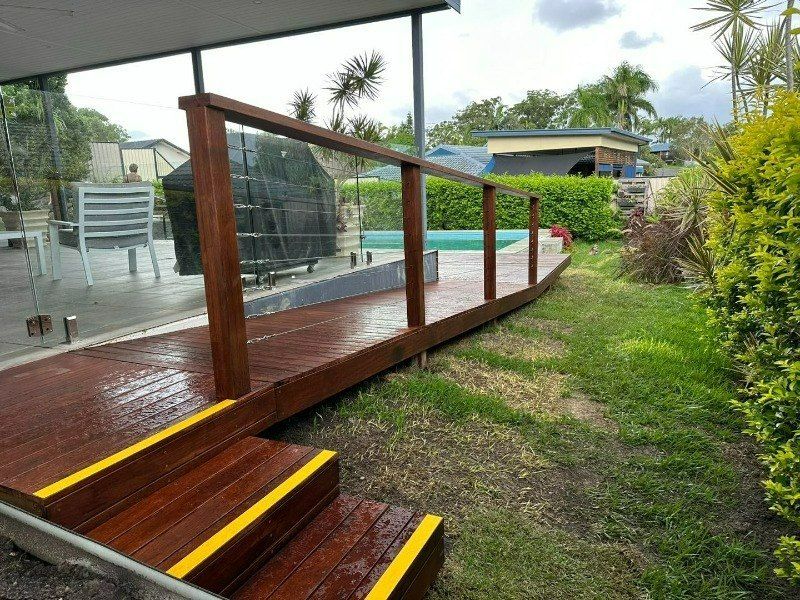 A Wooden Deck With Stairs Leading Up to It — Turnscape Landscaping in Beechmont, QLD