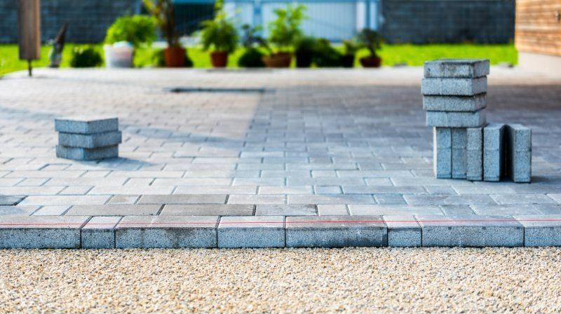A Stack of Bricks is Sitting on Top of a Brick Walkway — Turnscape Landscaping in Mudgeeraba, QLD