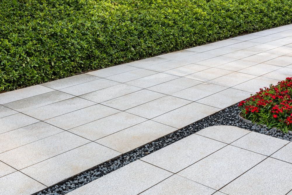 A sidewalk with flowers and bushes on the side of it — Turnscape Landscaping In Broadbeach, QLD