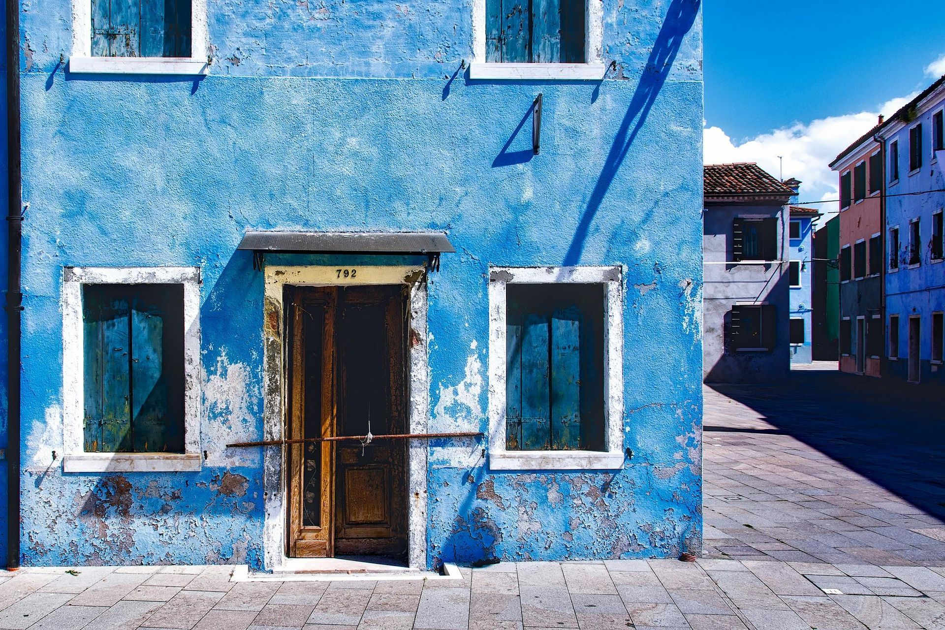 A blue building with a brown door and windows